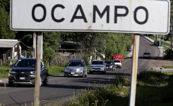 A hearse carrying the body of slain mayoral candidate Fernando Ángeles Juárez drives to a burial site last week in Ocampo, Mexico. A hearse carrying the body of slain mayoral candidate Fernando Ángeles Juárez drives to a burial site last week in Ocampo, Mexico.