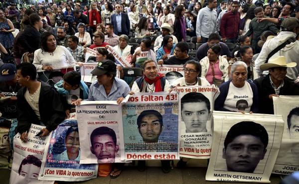 Parents and other relatives of the 43 missing students from the Ayotzinapa's teachers school attend the reading of the final report from the Interdisciplinary Group of Independent Experts (GIEI) in Mexico City on Sunday. Parents and other relatives of the 43 missing students from the Ayotzinapa's teachers school attend the reading of the final report from the Interdisciplinary Group of Independent Experts (GIEI) in Mexico City on Sunday.