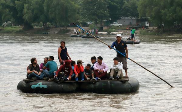 Central American migrants and a Spanish journalist ride a makeshift raft across the Suchiate River from Tecún Umán in Guatemala to Ciudad Hidalgo in Chiapas state, Mexico, on June 11. Central American migrants and a Spanish journalist ride a makeshift raft across the Suchiate River from Tecún Umán in Guatemala to Ciudad Hidalgo in Chiapas state, Mexico, on June 11.