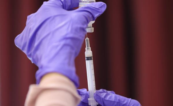 A nurse draw a Moderna COVID-19 vaccine dose from a vial at the Cameron Grove Community Center in Bowie, Md., in late March. Moderna says study data supports use of a half-dose of the vaccine in children 6 to 11. A nurse draw a Moderna COVID-19 vaccine dose from a vial at the Cameron Grove Community Center in Bowie, Md., in late March. Moderna says study data supports use of a half-dose of the vaccine in children 6 to 11.