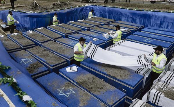 Volunteers bury the remains of more than 1,000 Holocaust victims at a cemetery just outside Brest, Belarus, on Wednesday. Volunteers bury the remains of more than 1,000 Holocaust victims at a cemetery just outside Brest, Belarus, on Wednesday.