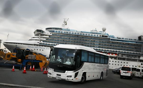 A bus departs from the dock where the Diamond Princess cruise ship sits under quarantine with its thousands of passengers and crew. Japanese authorities said Friday that some older passengers who tested negative for the coronavirus were allowed to disemba A bus departs from the dock where the Diamond Princess cruise ship sits under quarantine with its thousands of passengers and crew. Japanese authorities said Friday that some older passengers who tested negative for the coronavirus were allowed to disemba