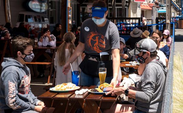 Patrons wear masks as they sit on the outdoor patio of a restaurant on Pier 39 at Fisherman's Wharf in San Francisco. California is among more than 20 states that require face masks to help combat the spread of the coronavirus. Patrons wear masks as they sit on the outdoor patio of a restaurant on Pier 39 at Fisherman's Wharf in San Francisco. California is among more than 20 states that require face masks to help combat the spread of the coronavirus.