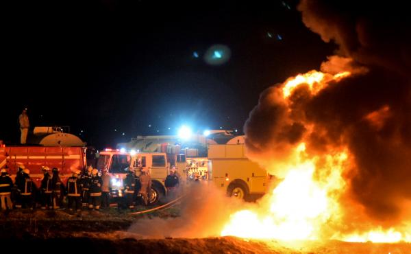 Firefighters work to extinguish a massive blaze triggered by a leaking pipeline in Tlahuelilpan, Mexico on Friday night. At least 66 people were killed. Firefighters work to extinguish a massive blaze triggered by a leaking pipeline in Tlahuelilpan, Mexico on Friday night. At least 66 people were killed.