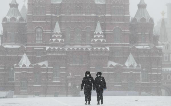 Police officers walk across an empty Red Square in Moscow on Tuesday, as the Russian capital goes into lockdown to stem the spread of the new coronavirus. Police officers walk across an empty Red Square in Moscow on Tuesday, as the Russian capital goes into lockdown to stem the spread of the new coronavirus.