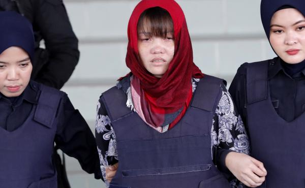 Vietnamese Doan Thi Huong, center, is escorted by police as she leaves Shah Alam High Court in Malaysia on Thursday. Malaysia's attorney general ordered the murder case to proceed against the Vietnamese woman accused in the killing of the North Korean lea Vietnamese Doan Thi Huong, center, is escorted by police as she leaves Shah Alam High Court in Malaysia on Thursday. Malaysia's attorney general ordered the murder case to proceed against the Vietnamese woman accused in the killing of the North Korean lea