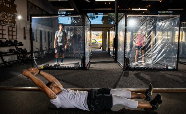 Peet Sapsin directs clients inside custom built "Gainz Pods", during his HIIT class, (high intensity interval training), at Sapsins Inspire South Bay Fitness, Redondo Beach, California, Wednesday, June 17, 2020. Peet Sapsin directs clients inside custom built "Gainz Pods", during his HIIT class, (high intensity interval training), at Sapsins Inspire South Bay Fitness, Redondo Beach, California, Wednesday, June 17, 2020.