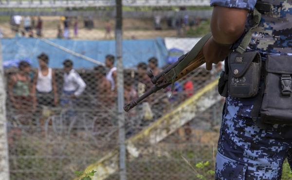 Myanmar border guard police patrol the fence in the "no man's land" zone between Myanmar and Bangladesh, as seen from Maungdaw, Rakhine state, during a government-organized visit for journalists on Aug. 24. A new U.N. report finds that Myanmar's military Myanmar border guard police patrol the fence in the "no man's land" zone between Myanmar and Bangladesh, as seen from Maungdaw, Rakhine state, during a government-organized visit for journalists on Aug. 24. A new U.N. report finds that Myanmar's military