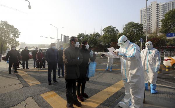 People in Wuhan, China, line up at a facility that tests discharged COVID-19 patients as well as individuals who had been held in isolation. People in Wuhan, China, line up at a facility that tests discharged COVID-19 patients as well as individuals who had been held in isolation.