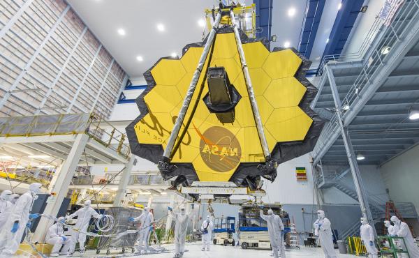 In 2017, technicians lift the mirror assembly of the James Webb Space Telescope using a crane inside a clean room at NASA's Goddard Space Flight Center in Greenbelt, Md. In 2017, technicians lift the mirror assembly of the James Webb Space Telescope using a crane inside a clean room at NASA's Goddard Space Flight Center in Greenbelt, Md.