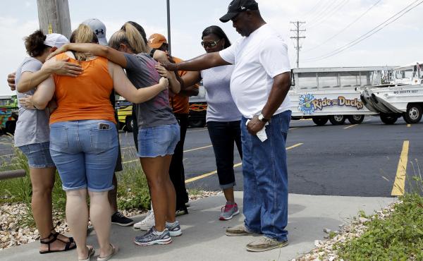 People pray outside Ride the Ducks, an amphibious tour operator involved in a 2018 boating accident on Table Rock Lake near Branson, Mo. People pray outside Ride the Ducks, an amphibious tour operator involved in a 2018 boating accident on Table Rock Lake near Branson, Mo.