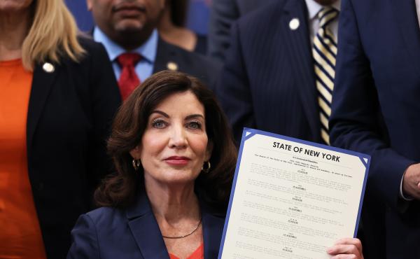 New York Gov. Kathy Hochul announced that she is pledging $10 million to establish new teams in every county and in New York City dedicated primarily to combat domestic terrorism. Here, Hochul holds up signed legislation as she is surrounded by lawmakers New York Gov. Kathy Hochul announced that she is pledging $10 million to establish new teams in every county and in New York City dedicated primarily to combat domestic terrorism. Here, Hochul holds up signed legislation as she is surrounded by lawmakers