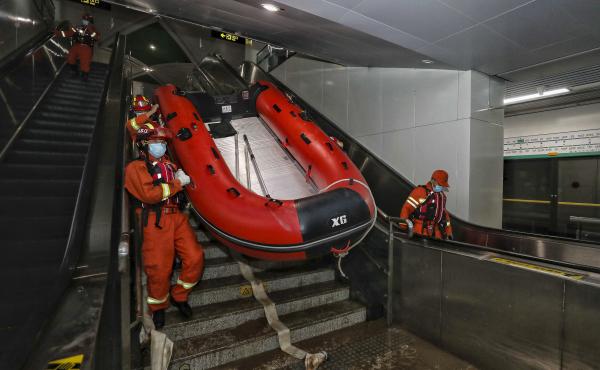 Rescuers carry a boat into the subway in Zhengzhou, China, in July after flash floods trapped passengers underground. Rescuers carry a boat into the subway in Zhengzhou, China, in July after flash floods trapped passengers underground.
