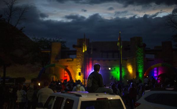 Matthew Slick is silhouetted by the purple light as the Navajo Council Chamber is lit in rainbow colors for Pride on June 28 in Window Rock, Ariz., the capital of the Navajo Nation. Matthew Slick is silhouetted by the purple light as the Navajo Council Chamber is lit in rainbow colors for Pride on June 28 in Window Rock, Ariz., the capital of the Navajo Nation.