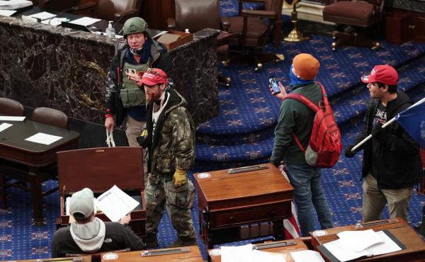 Larry Rendall Brock Jr., an Air Force veteran, is seen inside the Senate Chamber wearing a military-style helmet and tactical vest during the rioting at the U.S. Capitol. Federal prosecutors have alleged that before the attack, Brock posted on Facebook ab Larry Rendall Brock Jr., an Air Force veteran, is seen inside the Senate Chamber wearing a military-style helmet and tactical vest during the rioting at the U.S. Capitol. Federal prosecutors have alleged that before the attack, Brock posted on Facebook ab