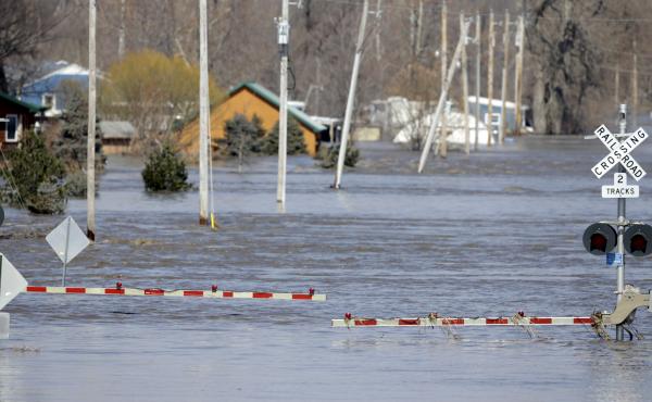 A railroad crossing is flooded with water from the Platte River in Plattsmouth, Neb. Record high floodwaters inundated regions of the Midwest following an intense winter storm and rapid snowmelt. A railroad crossing is flooded with water from the Platte River in Plattsmouth, Neb. Record high floodwaters inundated regions of the Midwest following an intense winter storm and rapid snowmelt.