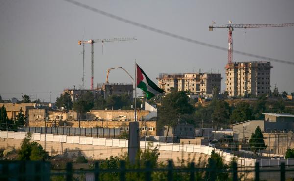 A Palestinian flag waves at the northern entrance to the city of Ramallah in the occupied West Bank as construction works take place in the Israeli settlement of Beit El in the background. Israel intends to annex West Bank settlements and the Jordan Valle A Palestinian flag waves at the northern entrance to the city of Ramallah in the occupied West Bank as construction works take place in the Israeli settlement of Beit El in the background. Israel intends to annex West Bank settlements and the Jordan Valle