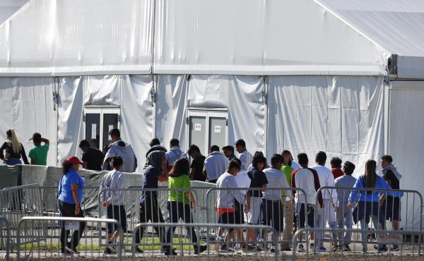 Migrant children line up to enter a tent at the Homestead Temporary Shelter for Unaccompanied Children in Homestead, Fla. in February 2019. Migrant children line up to enter a tent at the Homestead Temporary Shelter for Unaccompanied Children in Homestead, Fla. in February 2019.