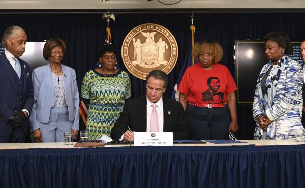 New York Gov. Andrew Cuomo, center, signs into law a sweeping package of police accountability measures on Friday that received new backing following protests of George Floyd's killing. New York Gov. Andrew Cuomo, center, signs into law a sweeping package of police accountability measures on Friday that received new backing following protests of George Floyd's killing.