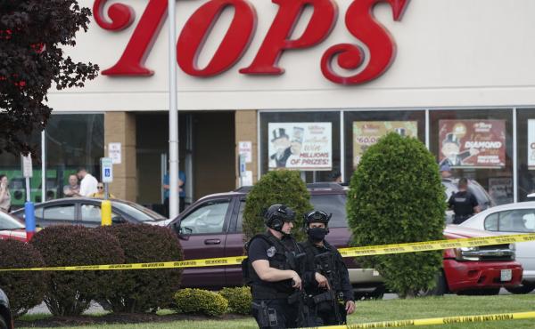 Police secure an area around a supermarket where several people were killed in a shooting, Saturday, May 14, 2022, in Buffalo, N.Y. Police secure an area around a supermarket where several people were killed in a shooting, Saturday, May 14, 2022, in Buffalo, N.Y.