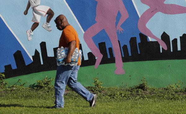A Newark, N.J., resident carries a case of bottled water distributed Monday at a recreation center. The Environmental Protection Agency said residents shouldn't rely on water filters the city gave out to address lead contamination. A Newark, N.J., resident carries a case of bottled water distributed Monday at a recreation center. The Environmental Protection Agency said residents shouldn't rely on water filters the city gave out to address lead contamination.