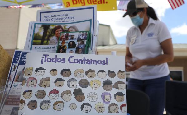 U.S. Census Bureau worker Marisela Gonzales stands by a display of books and flyers about the 2020 census at a walk-up counting site in Greenville, Texas, in July. The bureau's employees are under a time crunch to try to complete the national head count a U.S. Census Bureau worker Marisela Gonzales stands by a display of books and flyers about the 2020 census at a walk-up counting site in Greenville, Texas, in July. The bureau's employees are under a time crunch to try to complete the national head count a