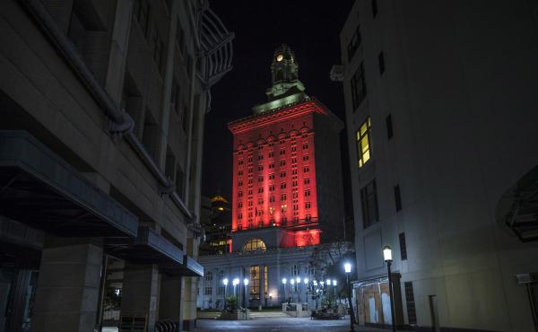 Oakland City Hall is bathed in red light in a memorial to the people who have died from COVID-19 throughout the country in Oakland, Calif. in January 2021. Oakland City Hall is bathed in red light in a memorial to the people who have died from COVID-19 throughout the country in Oakland, Calif. in January 2021.