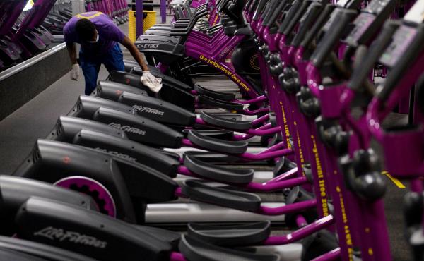 A Planet Fitness employee cleans equipment before a gym's reopening in March in Inglewood, Calif., after being closed due to COVID-19. Reduced access to recreation likely has contributed to weight gain during the pandemic. A Planet Fitness employee cleans equipment before a gym's reopening in March in Inglewood, Calif., after being closed due to COVID-19. Reduced access to recreation likely has contributed to weight gain during the pandemic.