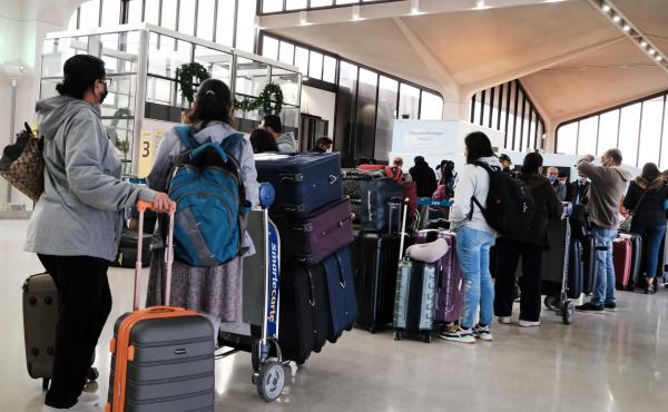 Travelers arrive for flights at Newark Liberty International Airport in New Jersey on Nov. 30. Travelers arrive for flights at Newark Liberty International Airport in New Jersey on Nov. 30.