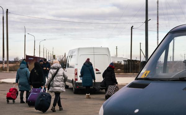 People crossing into Ukraine from Crimea board a minibus to continue on their way. People crossing into Ukraine from Crimea board a minibus to continue on their way.