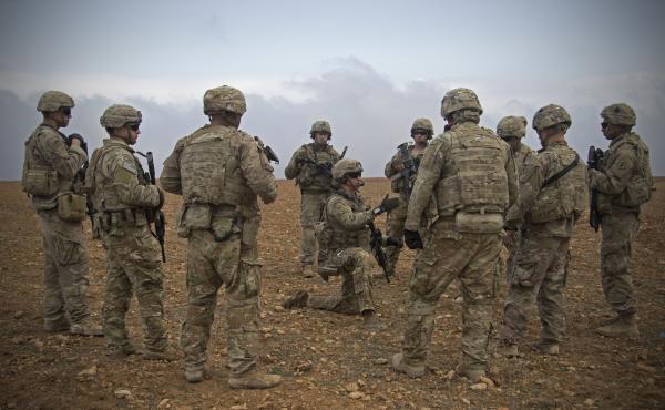 In this Nov. 7, 2018, photo released by the U.S. Army, U.S. soldiers gather for a brief during a combined joint patrol rehearsal in Manbij, Syria. In this Nov. 7, 2018, photo released by the U.S. Army, U.S. soldiers gather for a brief during a combined joint patrol rehearsal in Manbij, Syria.