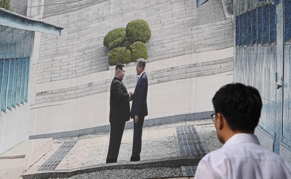 A man walks past a giant banner showing a picture of the summit handshake between South Korean President Moon Jae-in and North Korean leader Kim Jong Un, at Seoul City Hall on Sept, 13. Moon will fly to North Korea's capital on Sept. 18 for a third summit A man walks past a giant banner showing a picture of the summit handshake between South Korean President Moon Jae-in and North Korean leader Kim Jong Un, at Seoul City Hall on Sept, 13. Moon will fly to North Korea's capital on Sept. 18 for a third summit