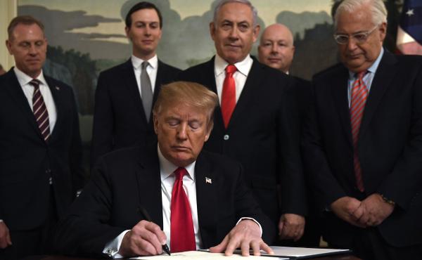 President Trump signs a proclamation at the White House on Monday officially recognizing Israel's sovereignty over the Golan Heights, with Israeli Prime Minister (center-right) among the officials looking on. President Trump signs a proclamation at the White House on Monday officially recognizing Israel's sovereignty over the Golan Heights, with Israeli Prime Minister (center-right) among the officials looking on.