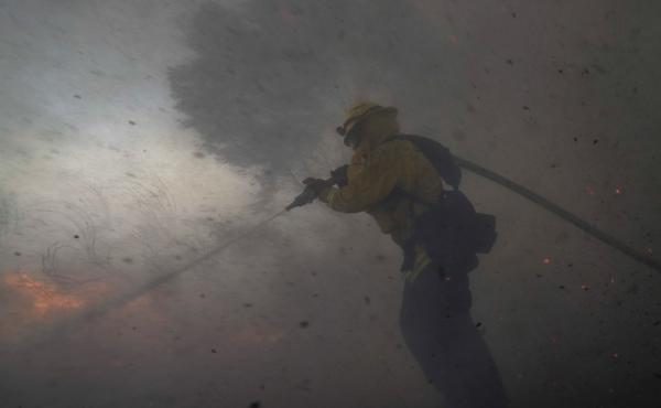 A firefighter battles the Silverado Fire Monday,in Irvine, Calif. The wildfire forced evacuation orders for 60,000 people in Southern California. A firefighter battles the Silverado Fire Monday,in Irvine, Calif. The wildfire forced evacuation orders for 60,000 people in Southern California.