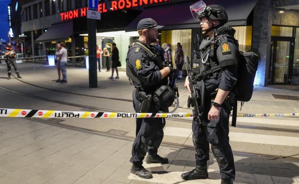 Police stand guard outside a bar in central Oslo, early Saturday. Norwegian police say two people have been killed and several injured in a mass shooting. Police stand guard outside a bar in central Oslo, early Saturday. Norwegian police say two people have been killed and several injured in a mass shooting.