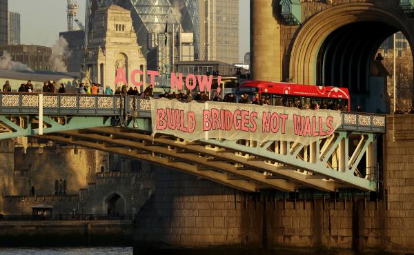 "Build Bridges Not Walls," reads a banner held by demonstrators on London's Tower Bridge to protest Donald Trump's inauguration as U.S. president on Friday. "Build Bridges Not Walls," reads a banner held by demonstrators on London's Tower Bridge to protest Donald Trump's inauguration as U.S. president on Friday.