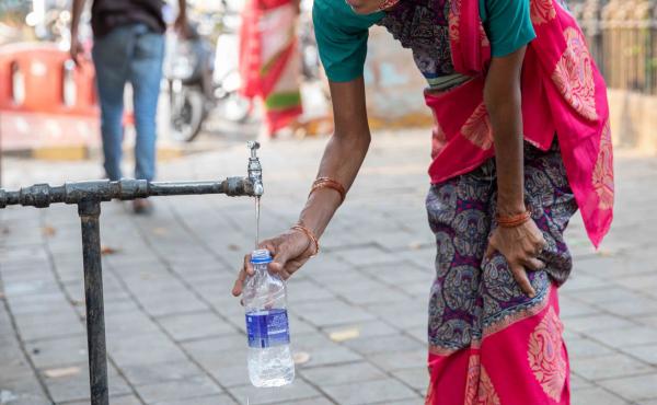 A woman fills a bottle from the tap at the Seth Gangalal V. Mulji Nandlal fountain. Researchers and water rights activist say the pandemic has exacerbated the huge inequality in Mumbai's water supply, with lower-income families struggling to find affordab A woman fills a bottle from the tap at the Seth Gangalal V. Mulji Nandlal fountain. Researchers and water rights activist say the pandemic has exacerbated the huge inequality in Mumbai's water supply, with lower-income families struggling to find affordab