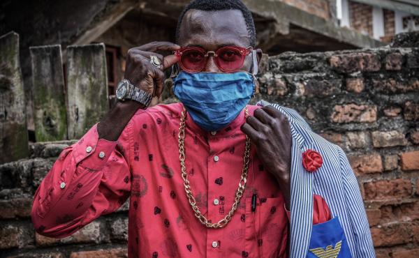 Anglebert Maurice Kakuja, 29, a Sapeur, or Congolese dandy, shows off his fashion sense while wearing a homemade mask in the eastern Congolese city of Bukavu. Sapeurs take their name from the acronym for their group: Societe des Ambianceurs et des Personn Anglebert Maurice Kakuja, 29, a Sapeur, or Congolese dandy, shows off his fashion sense while wearing a homemade mask in the eastern Congolese city of Bukavu. Sapeurs take their name from the acronym for their group: Societe des Ambianceurs et des Personn