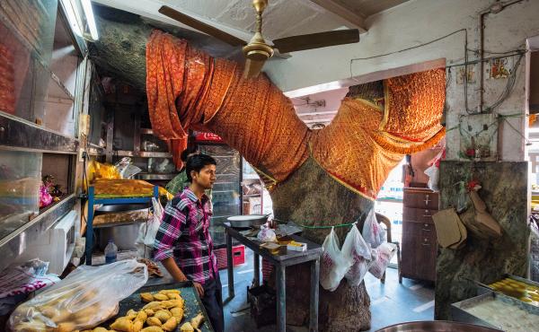 The Sardar Sweet Shop in Varanasi, India, was built around a neem tree considered too holy to cut down. Customers flow in and out, barely noticing the imposing tree. In rural parts, people use the neem tree's leaves to repel insects, the sap for stomach The Sardar Sweet Shop in Varanasi, India, was built around a neem tree considered too holy to cut down. Customers flow in and out, barely noticing the imposing tree. In rural parts, people use the neem tree's leaves to repel insects, the sap for stomach