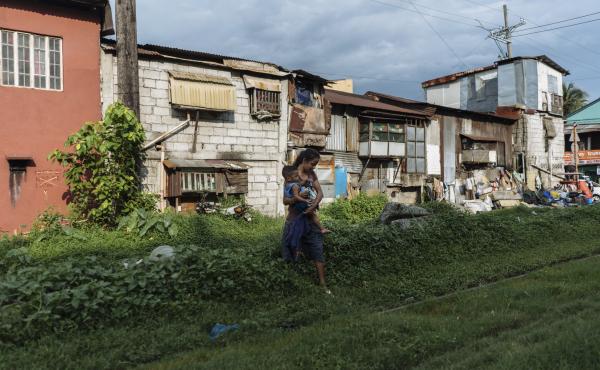 Ros Jane walks with her child by the railway near her home in Manila. She became pregnant at age 16. Ros Jane walks with her child by the railway near her home in Manila. She became pregnant at age 16.