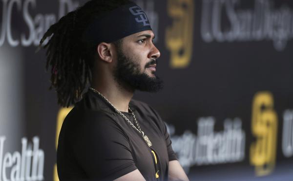 San Diego Padres' Fernando Tatis Jr. looks out from the dugout prior to the team's game against the Philadelphia Phillies on June 25 in San Diego. Tatis was suspended 80 games by Major League Baseball on Friday after testing positive for a performance-enh San Diego Padres' Fernando Tatis Jr. looks out from the dugout prior to the team's game against the Philadelphia Phillies on June 25 in San Diego. Tatis was suspended 80 games by Major League Baseball on Friday after testing positive for a performance-enh
