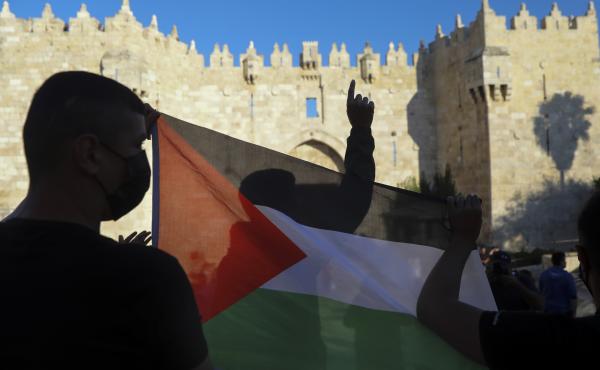 Demonstrators wave the Palestinian flag during a protest in Damascus Gate, just outside Jerusalem's Old City on June 19. Palestinians and Jewish settlers hurled stones, chairs and fireworks at each other in a tense Jerusalem neighborhood, where settler gr Demonstrators wave the Palestinian flag during a protest in Damascus Gate, just outside Jerusalem's Old City on June 19. Palestinians and Jewish settlers hurled stones, chairs and fireworks at each other in a tense Jerusalem neighborhood, where settler gr