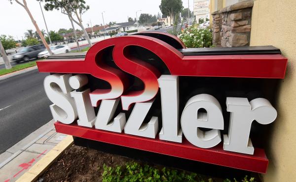 Sizzler USA has filed for bankruptcy as a result of the COVID-19 pandemic and related restrictions. Here, drivers pass a closed Sizzler restaurant in Montebello, Calif. Sizzler USA has filed for bankruptcy as a result of the COVID-19 pandemic and related restrictions. Here, drivers pass a closed Sizzler restaurant in Montebello, Calif.