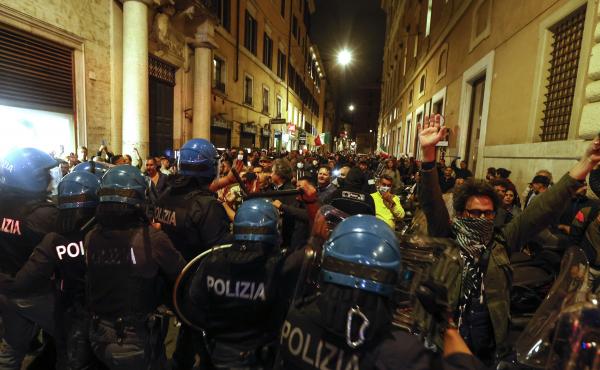 Anti-riot police officers face demonstrators trying to reach the Chigi Palace government office in Rome during a protest Saturday against green pass. Anti-riot police officers face demonstrators trying to reach the Chigi Palace government office in Rome during a protest Saturday against green pass.
