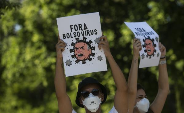 Demonstrators wearing protective face masks hold signs depicting President Jair Bolsonaro as a virus protest against the government's response in combating COVID-19, demanding the impeachment of Bolsonaro, in Rio de Janeiro, Brazil, Saturday, May 29, 2021 Demonstrators wearing protective face masks hold signs depicting President Jair Bolsonaro as a virus protest against the government's response in combating COVID-19, demanding the impeachment of Bolsonaro, in Rio de Janeiro, Brazil, Saturday, May 29, 2021