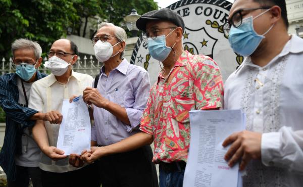 Martial law victims including former lawmaker Satur Ocampo (third from left) and their lawyers headed by Howard Calleja (second from left), show documents after filing a petition with the supreme Court in Manila on Wednesday seeking the disqualification o Martial law victims including former lawmaker Satur Ocampo (third from left) and their lawyers headed by Howard Calleja (second from left), show documents after filing a petition with the supreme Court in Manila on Wednesday seeking the disqualification o