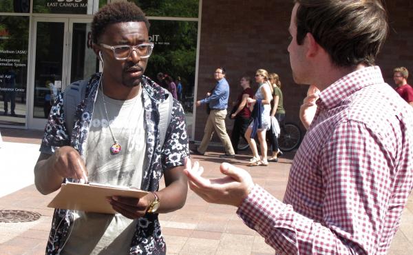 A University of Wisconsin student gets information about registering to vote from a NextGen America worker in Madison, Wis., in 2018. A University of Wisconsin student gets information about registering to vote from a NextGen America worker in Madison, Wis., in 2018.