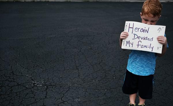 Derrick Slaughter attends a July 14, 2017, march through the streets of Norwalk, Ohio, against the epidemic of heroin, with his grandmother (not shown). Both of Derrick's parents are heroin addicts and he is now being raised by his grandparents. Derrick Slaughter attends a July 14, 2017, march through the streets of Norwalk, Ohio, against the epidemic of heroin, with his grandmother (not shown). Both of Derrick's parents are heroin addicts and he is now being raised by his grandparents.