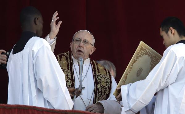 Pope Francis delivers his Christmas Day blessing from the main balcony of St. Peter's Basilica at the Vatican on Tuesday. Pope Francis delivers his Christmas Day blessing from the main balcony of St. Peter's Basilica at the Vatican on Tuesday.