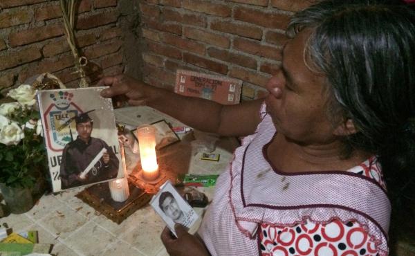 Natividad de la Cruz Bartolo shows a picture of her son, Emiliano, one of 43 university students who went missing months ago. Natividad de la Cruz Bartolo shows a picture of her son, Emiliano, one of 43 university students who went missing months ago.